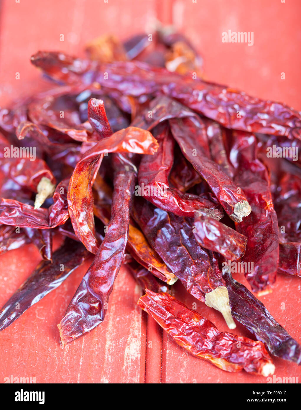Dried red pepper on a red table tp background Stock Photo