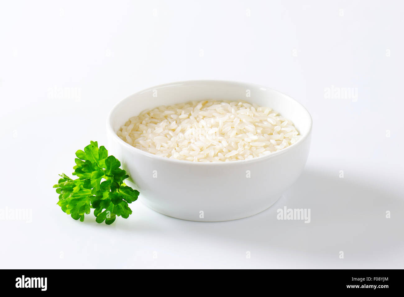 Bowl of uncooked white rice Stock Photo Alamy
