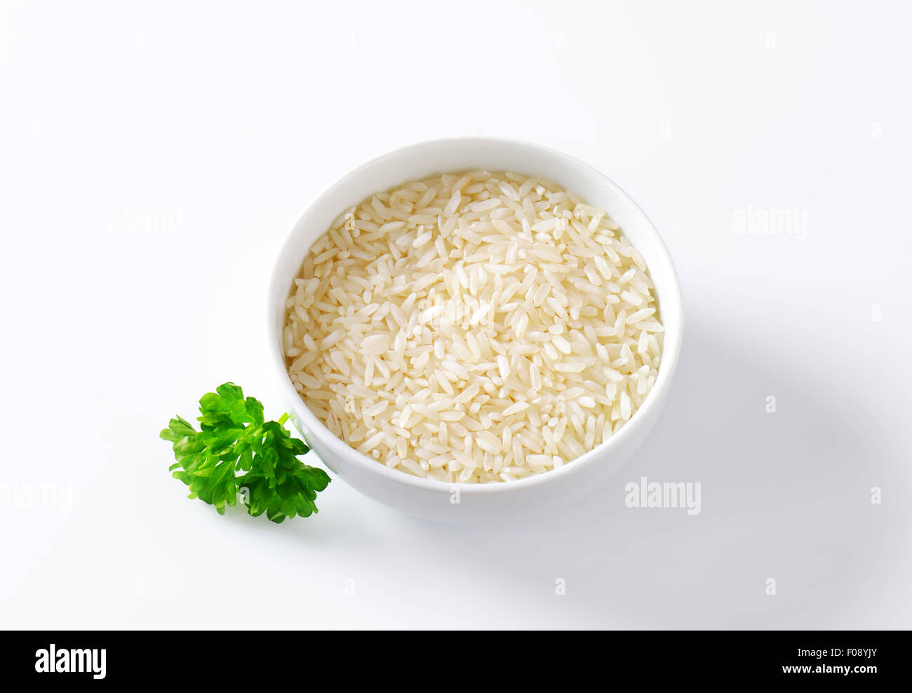 Bowl of uncooked white rice Stock Photo Alamy