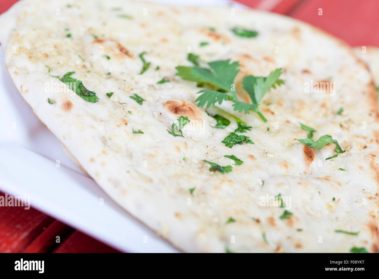 Traditional fresh baked naan bread with corriander Stock Photo