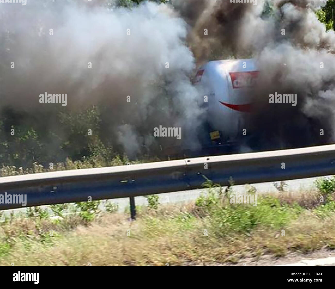 Manchester, UK. 10th Aug, 2015. M56 /Chester Manchester Monday 10th August 2015  A blazing tanker on the Chester bound carriageway of the M56 has closed the motorway in both directions.  The lorry is on the hard shoulder between J14 at Hapsford and Junction 15 at the M53 and a 1500 metres cordon has been set up.  Motorists within it are being evacuated from their vehicles and being moved to a safe distance.  Traffic is reportedly backed up from Daresbury and at a stand still. Credit:  jason kay/Alamy Live News Stock Photo