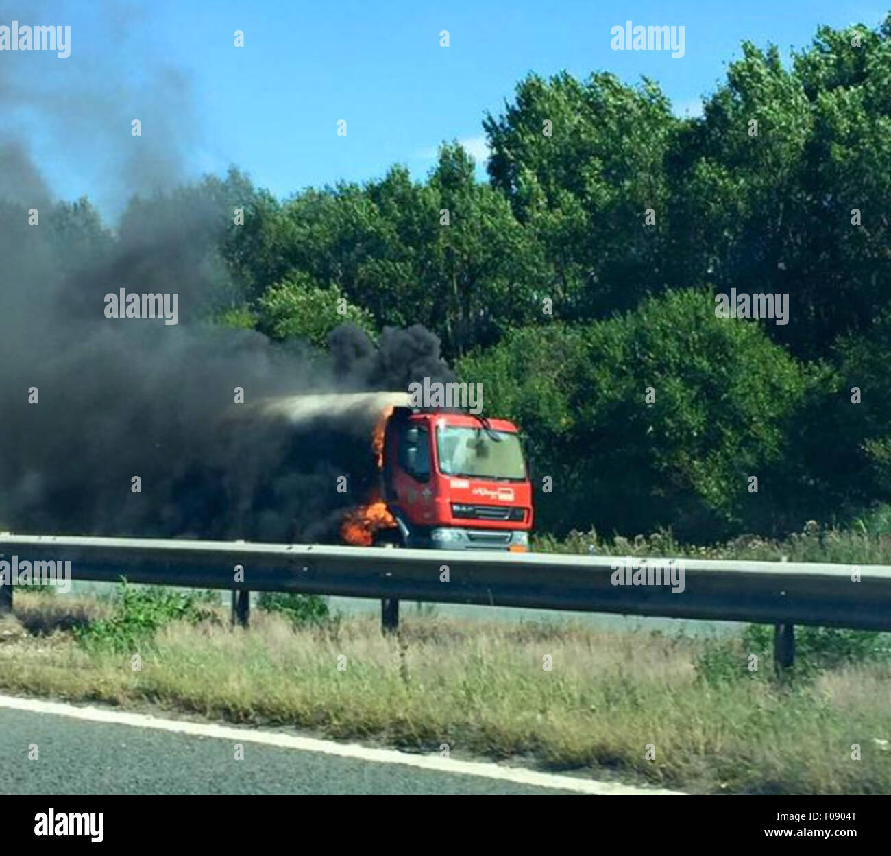 Manchester, UK. 10th Aug, 2015. M56 /Chester Manchester Monday 10th August 2015  A blazing tanker on the Chester bound carriageway of the M56 has closed the motorway in both directions.  The lorry is on the hard shoulder between J14 at Hapsford and Junction 15 at the M53 and a 1500 metres cordon has been set up.  Motorists within it are being evacuated from their vehicles and being moved to a safe distance.  Traffic is reportedly backed up from Daresbury and at a stand still. Credit:  jason kay/Alamy Live News Stock Photo