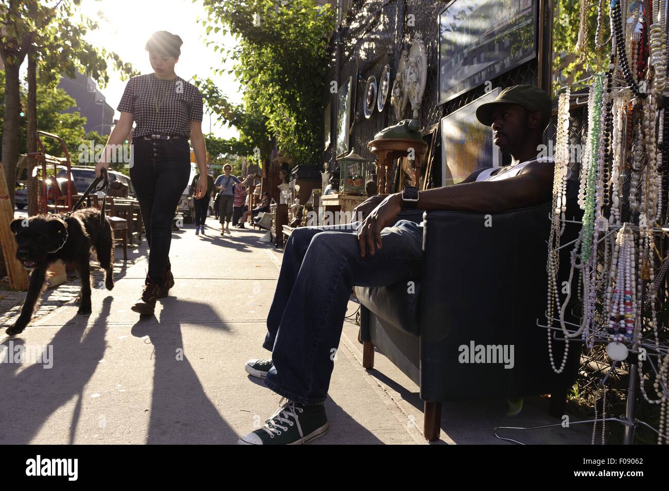 Rapper sitting in chair and selling his CD's on the road, New York, USA ...