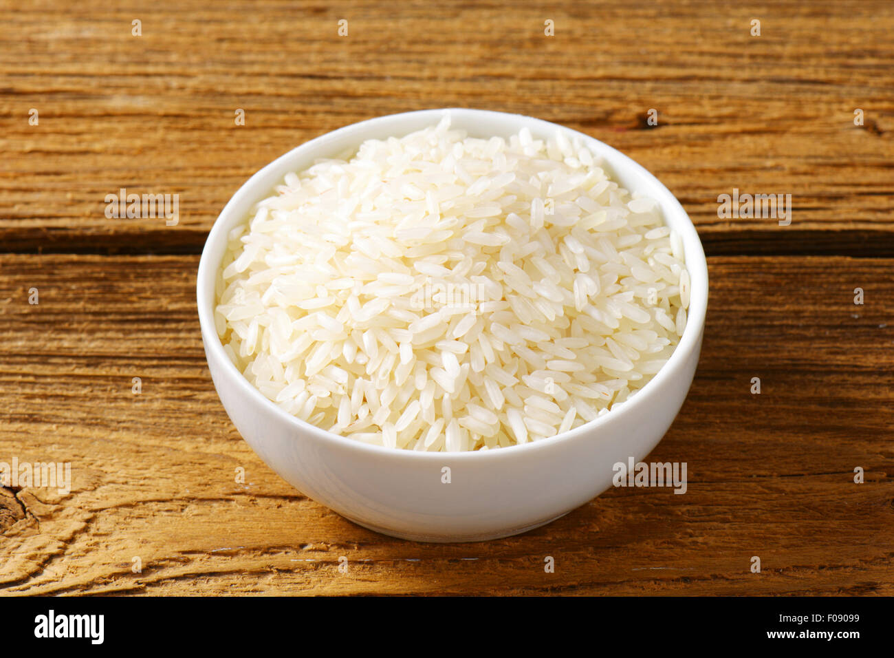 Bowl of uncooked white rice Stock Photo Alamy