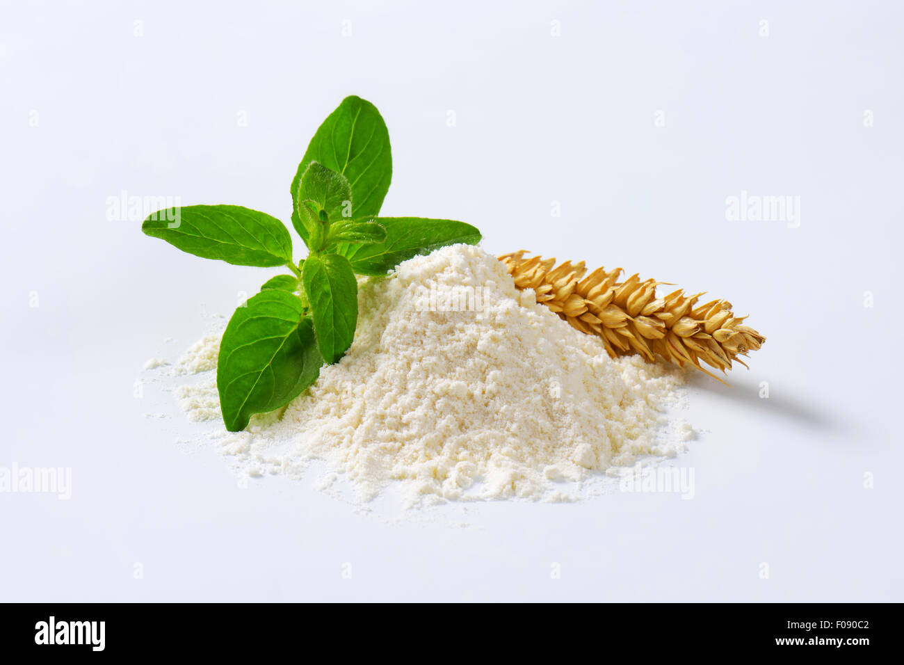 Pile of finely ground flour and wheat ear Stock Photo