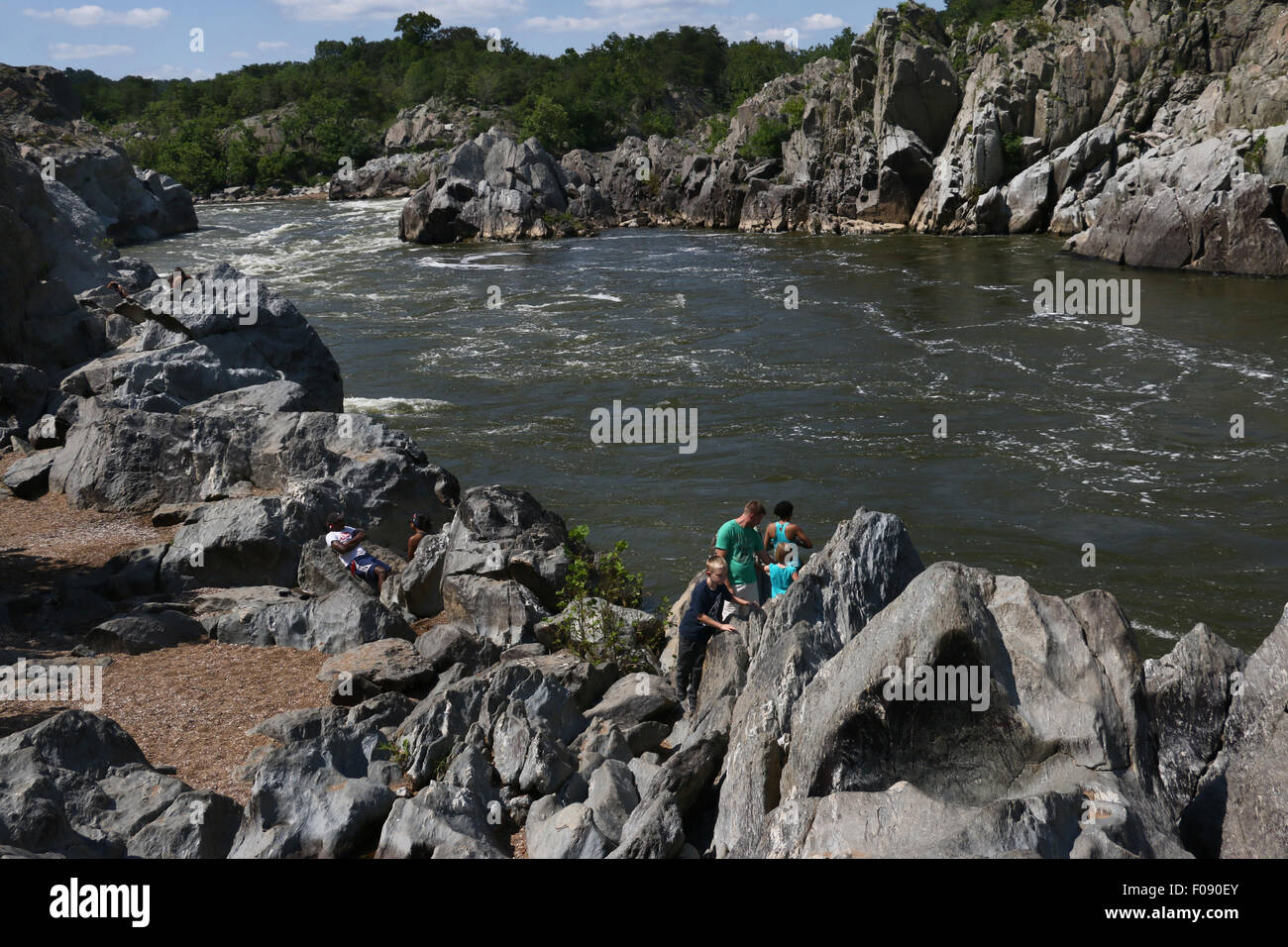 Hikers on rocks at the Great Falls of the Potomac River Maryland Stock Photo