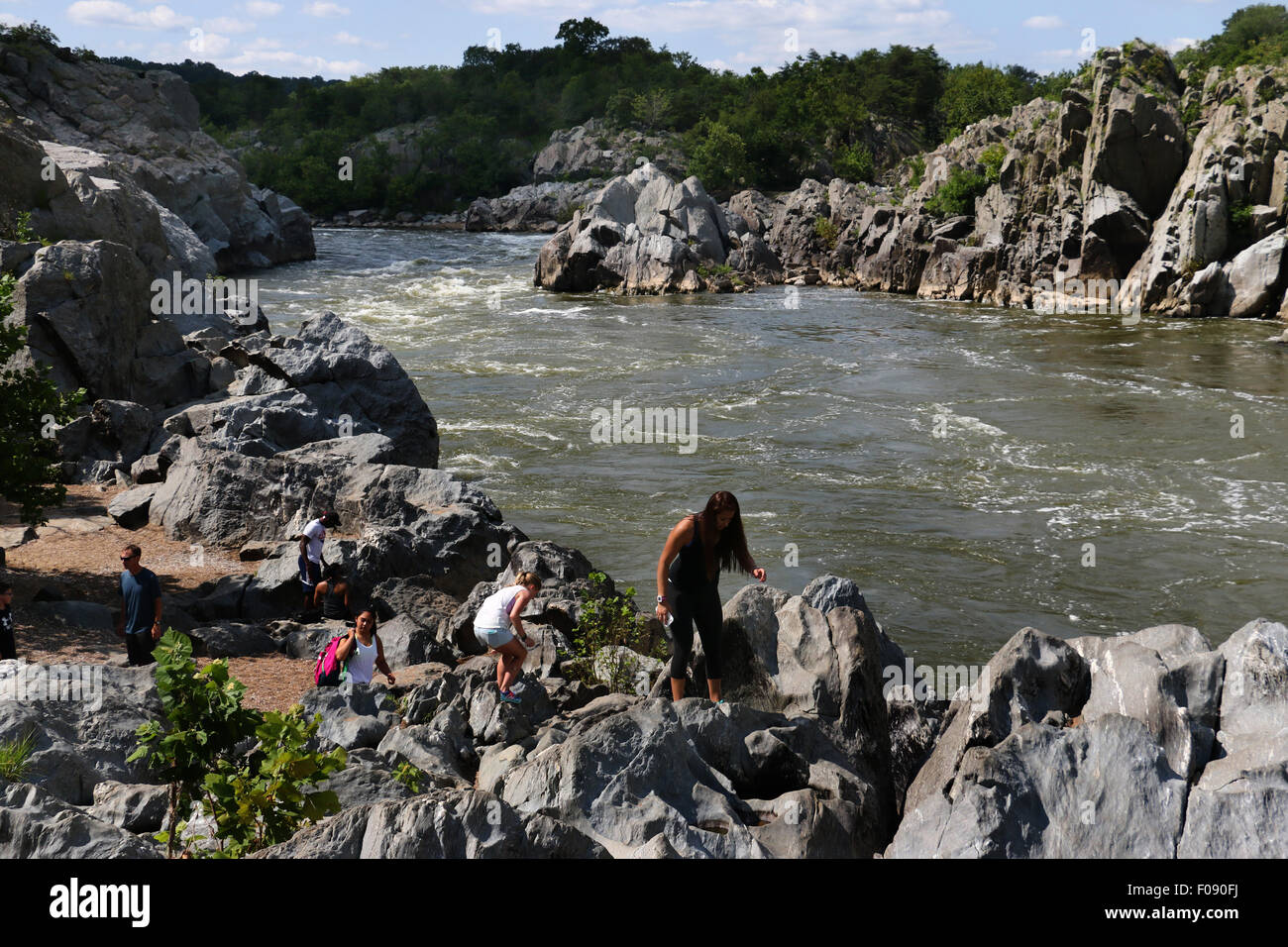 Hikers on rocks at the Great Falls of the Potomac River Maryland Stock Photo