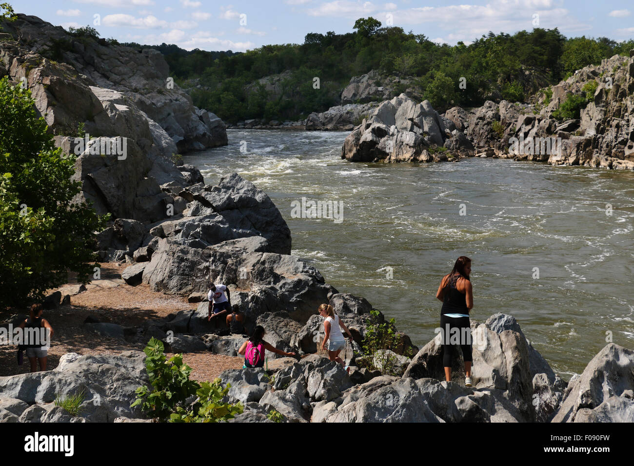 Hikers on rocks at the Great Falls of the Potomac River Maryland Stock Photo