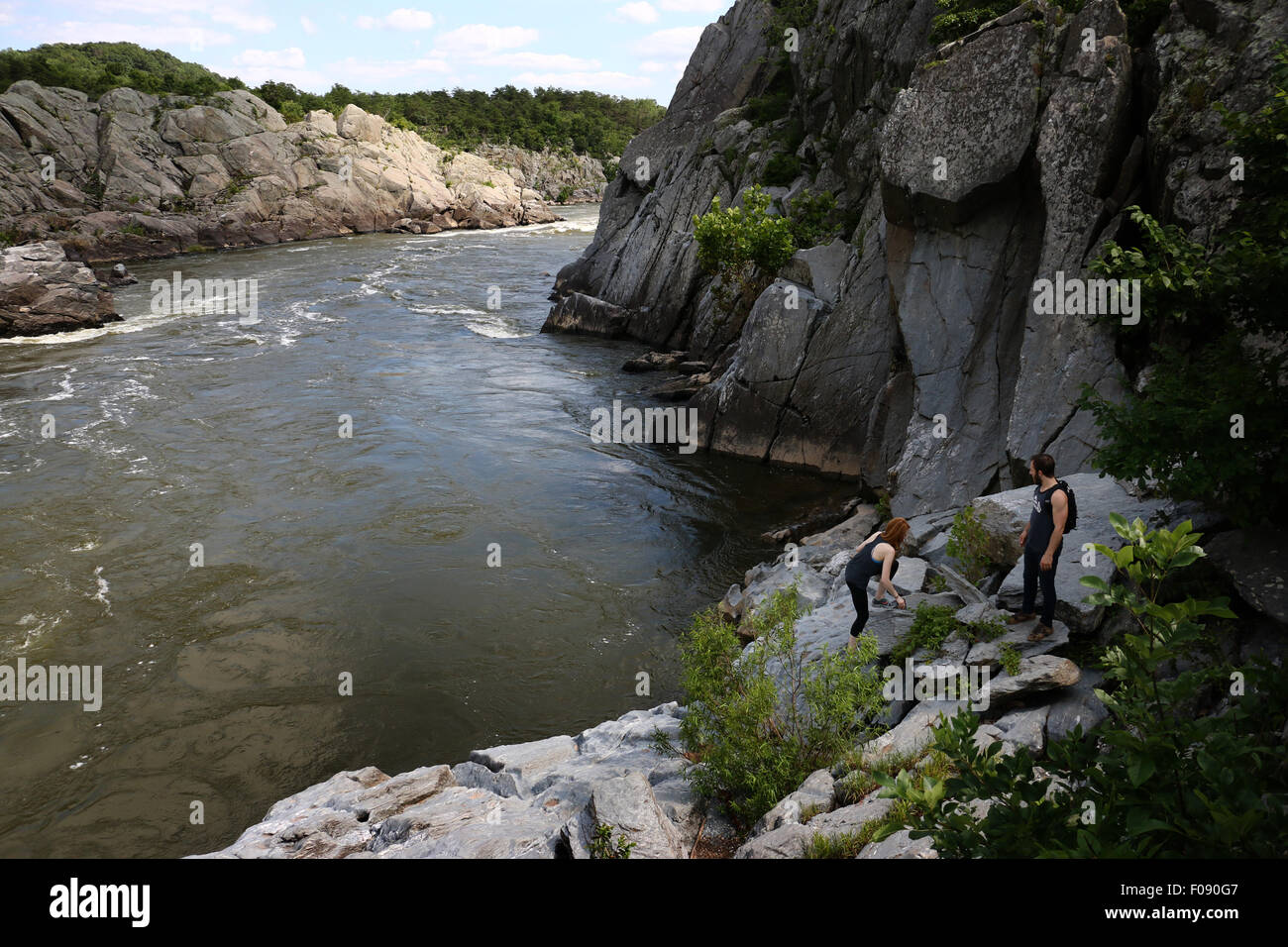 Hikers on rocks at the Great Falls of the Potomac River Maryland Stock Photo