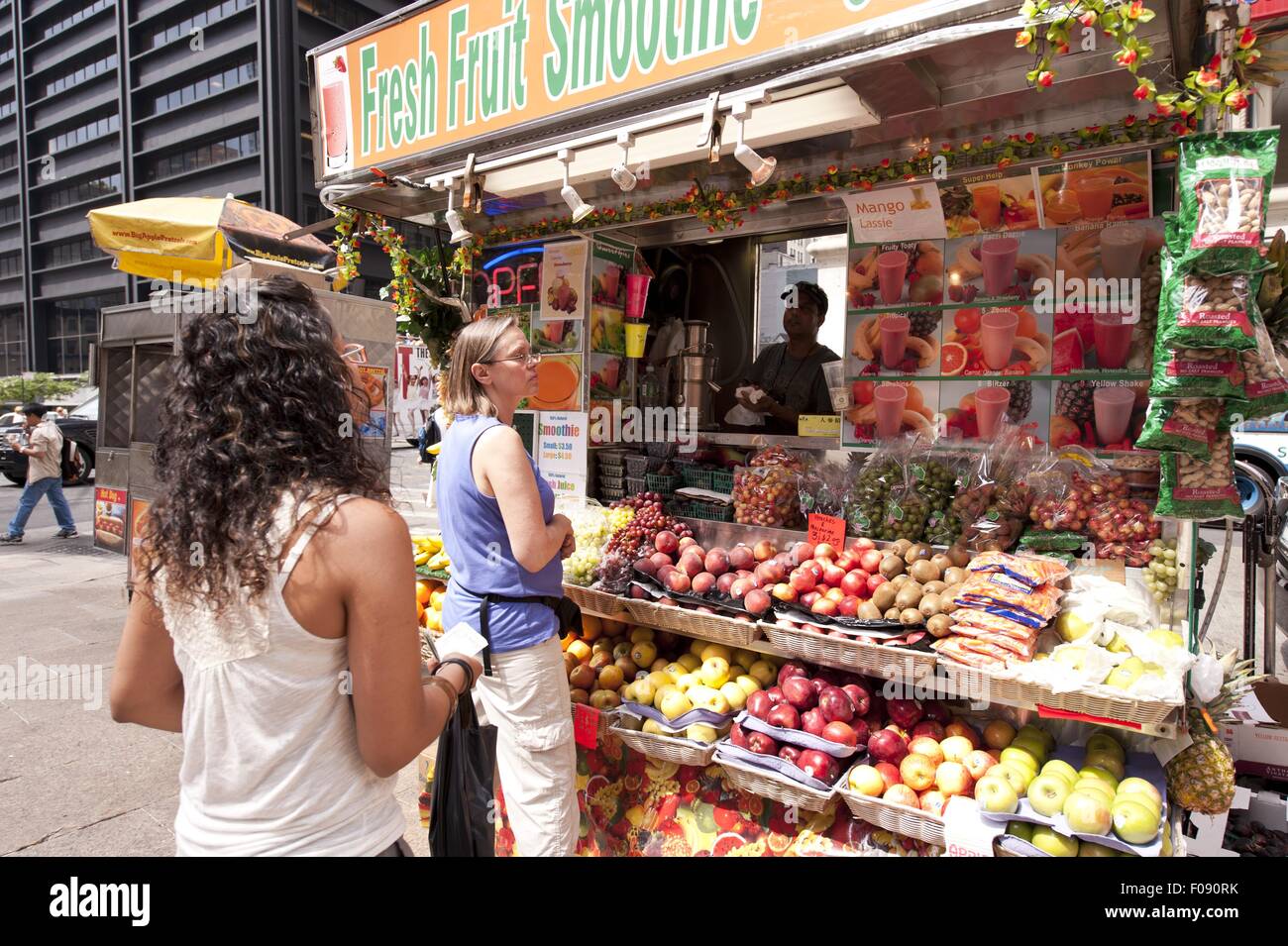 People buying fruits at Fresh Fruit Smoothies shop in New York, USA Stock Photo