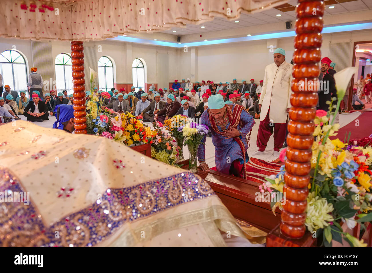 Guru Granth Sahib Sikh Holy Book and Congregation at Brent Cross Sikh Temple Stock Photo
