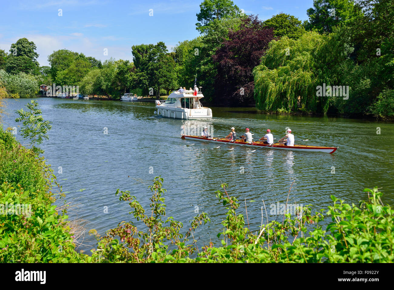Jeanneau Prestige 32 Boat cruise boat and rowing boat on River Thames, Runnymede, Surrey, England, United Kingdom Stock Photo