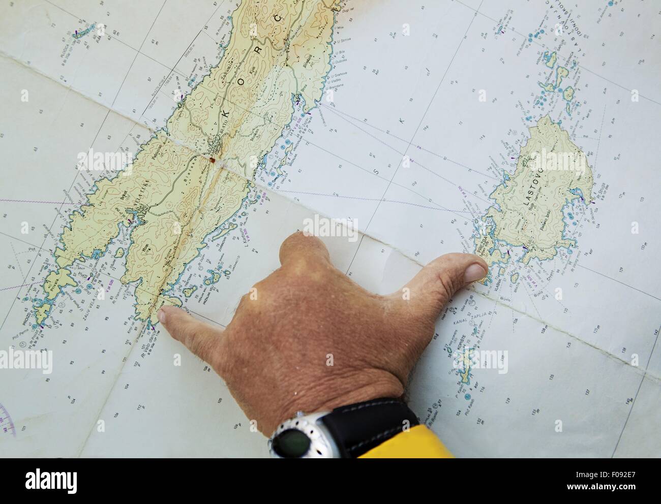 Close-up of man's hand measuring map Stock Photo