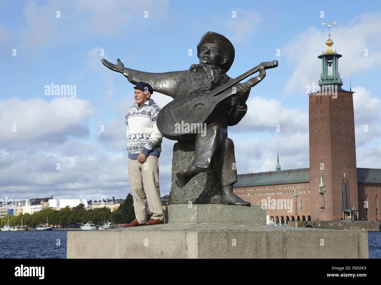 Man standing in front of Monument of National poet Evert Taube, Stockholm Stock Photo