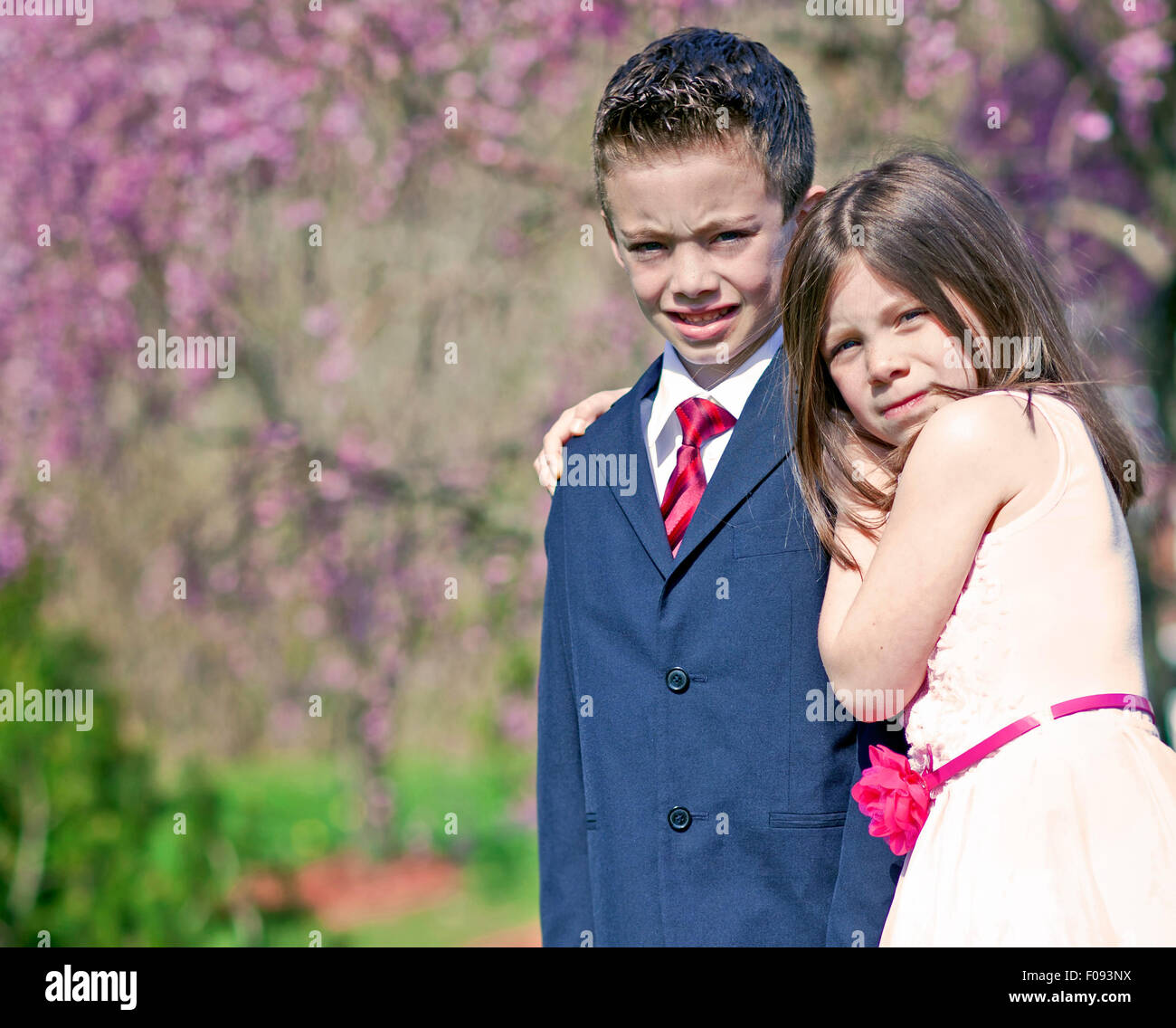 A young boy and girl standing outside portrait Stock Photo - Alamy