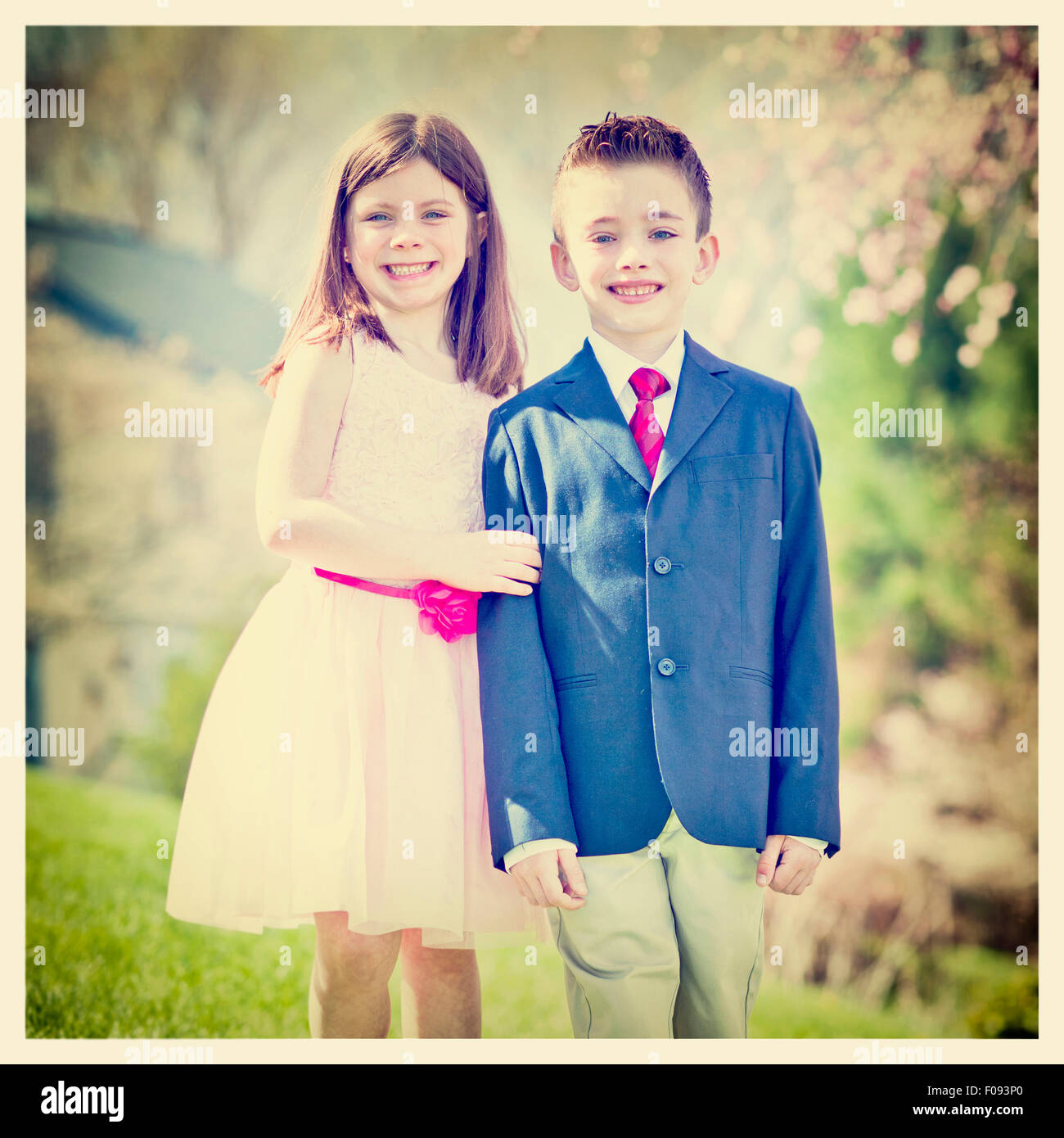 A young boy and girl standing outside portrait with Instagram effect ...