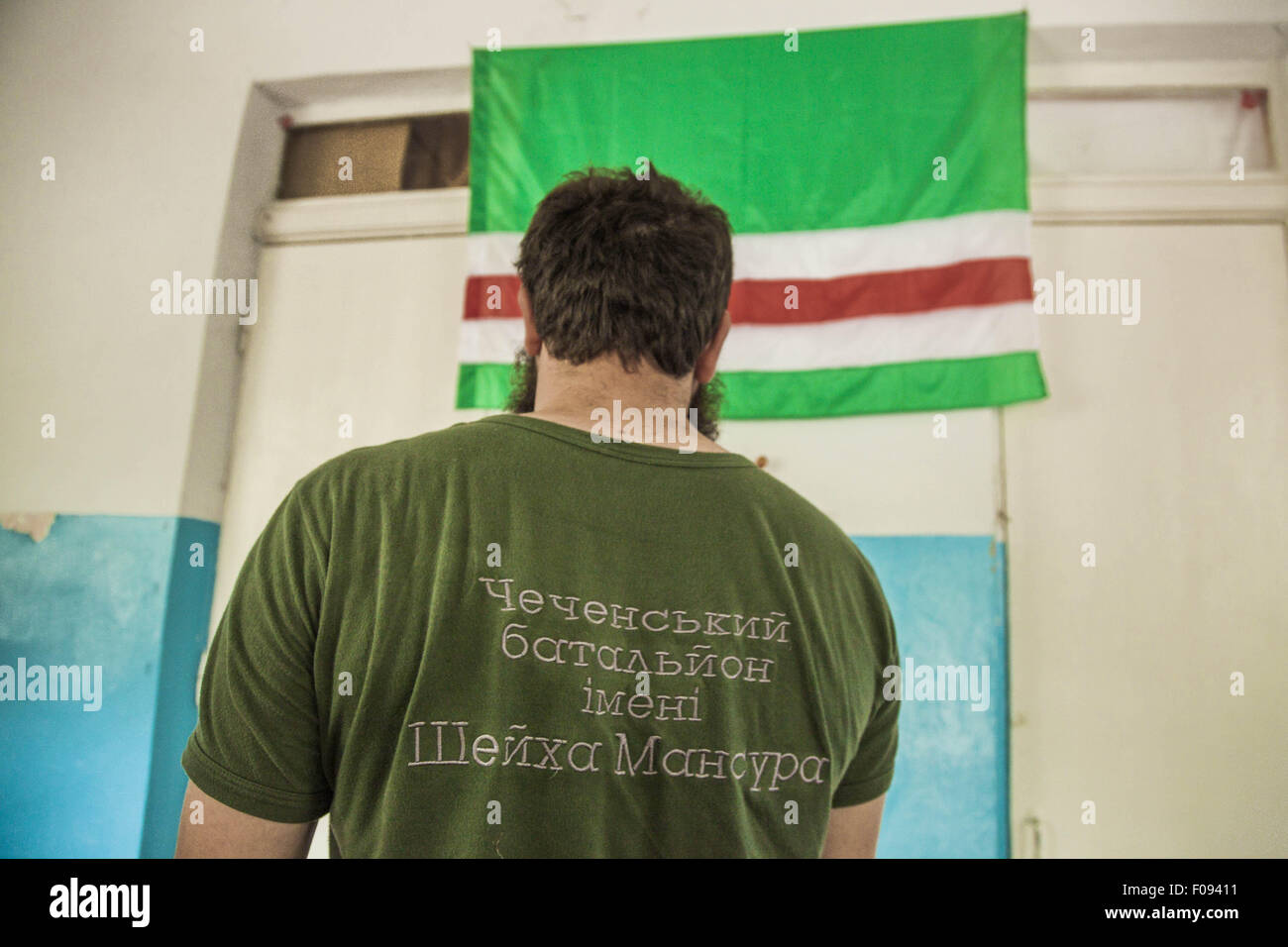 July 25, 2015 - Mariupol, Donetsk Oblast, Ukraine - T-shirt of a chechen fighter of the Sheikh Mansur battalion says ''chechen battalion, Sheikh Mansur'', in background the Chechnya flag in his base of Mariupol, Ukraine (Credit Image: © Celestino Arce via ZUMA Wire) Stock Photo