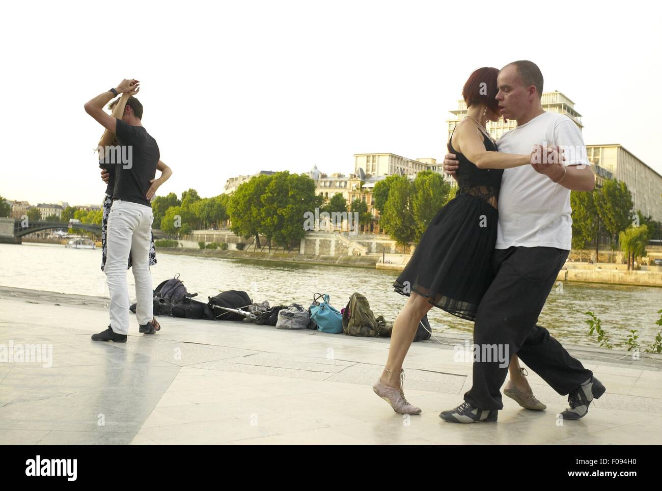 Paris Dancing Riverside Couple dancing at the bank of Seine River in Paris, France Stock Photo ...