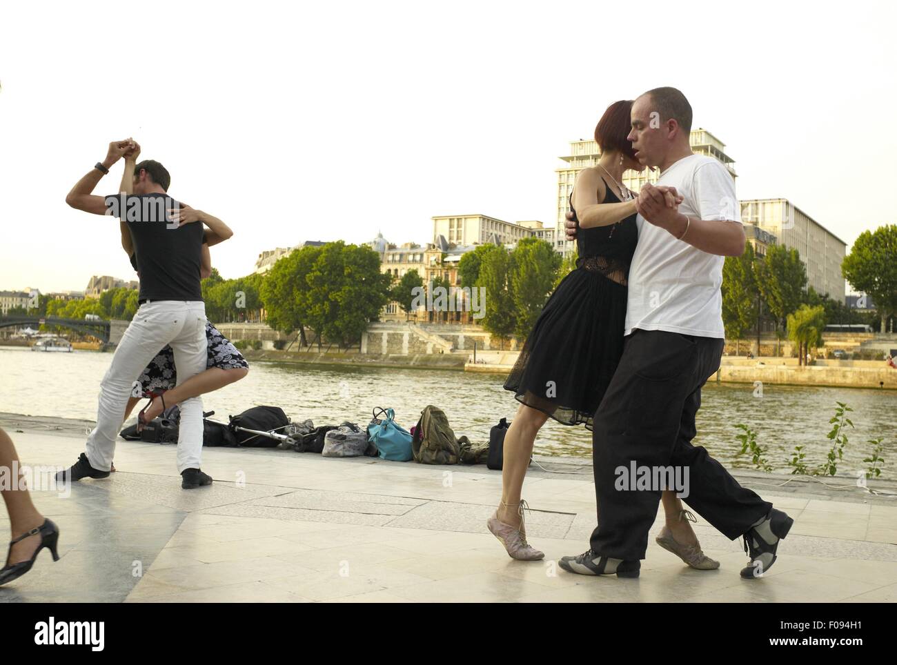 Paris Dancing Riverside Couple dancing at the bank of Seine River in Paris, France Stock Photo ...