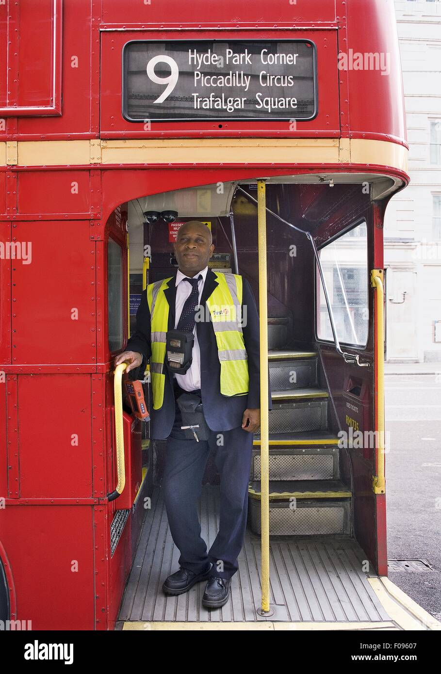 Bus conductor on bus 9 to Trafalgar Square, Hyde Park and Piccadilly Circus, London, UK Stock Photo
