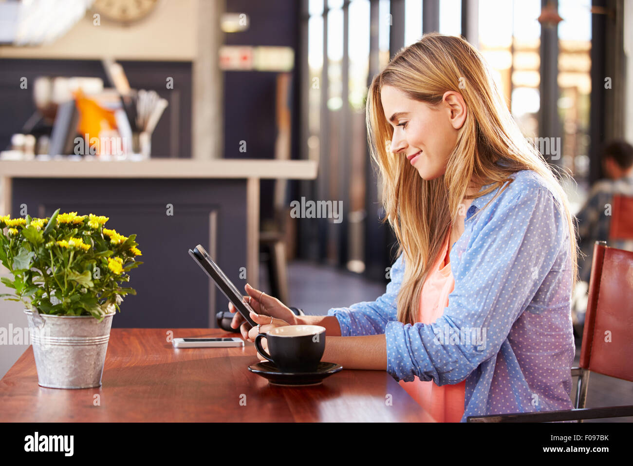 Young woman using computer at a coffee shop Stock Photo - Alamy