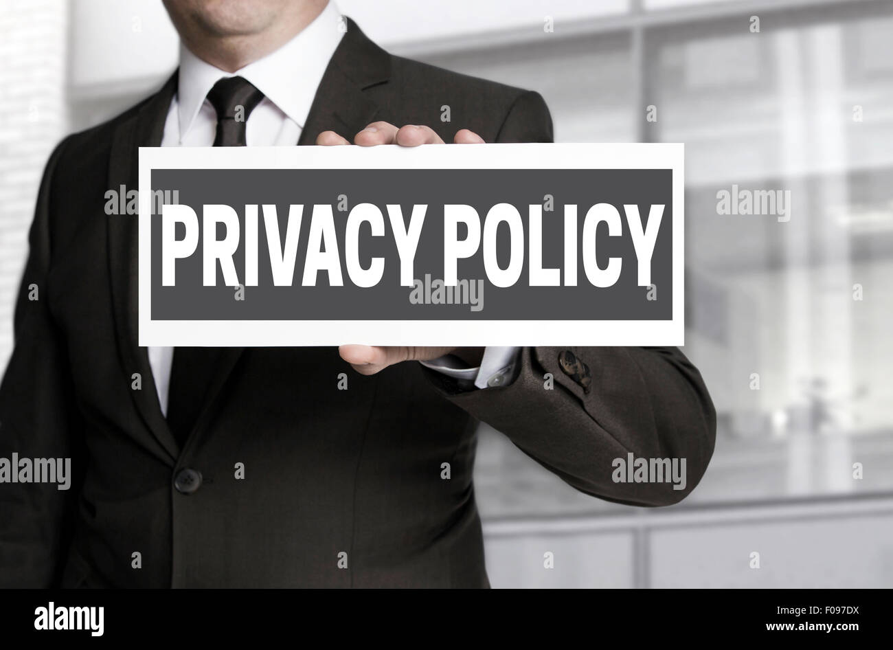 Privacy Policy sign is held by businessman. Stock Photo