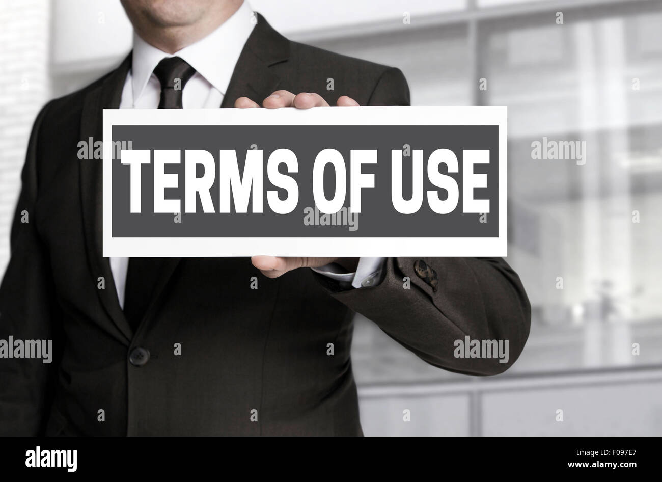 Terms of Use sign is held by businessman. Stock Photo