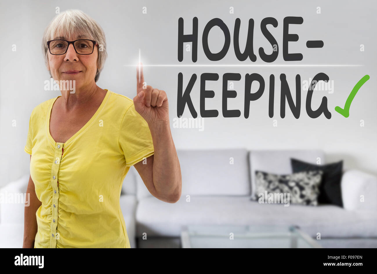 housekeeping touchscreen is shown by senior. Stock Photo