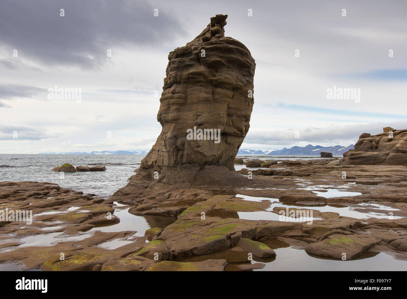 Sandstone rock formation on beach along the coast of Boltodden, Kvalvagen, Svalbard / Spitsbergen, Norway Stock Photo