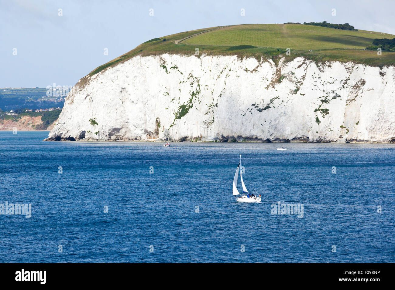 A yacht passing The Foreland or Handfast Point and Ballard Down between Studland Bay and Swanage Bay near Swanage, Dorset UK Stock Photo