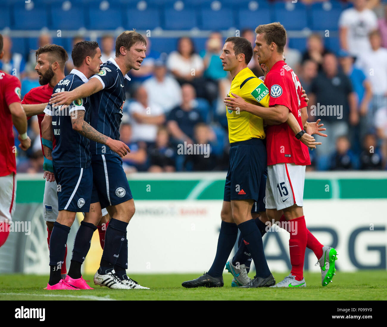 Referee Benjamin Brand attempts to calm arguing players, Hertha's Stock
