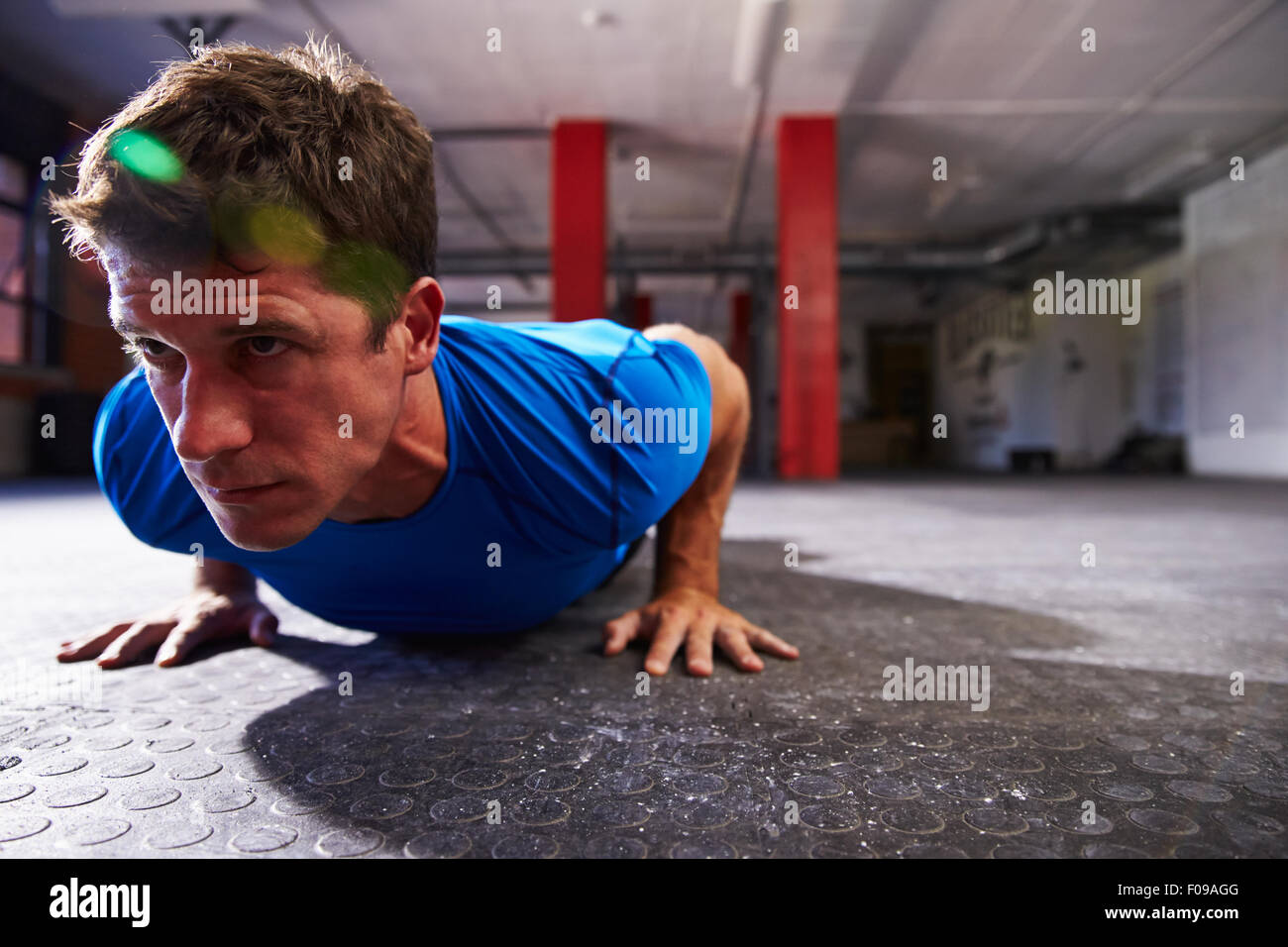 Man In Gym Doing Press-Ups Stock Photo
