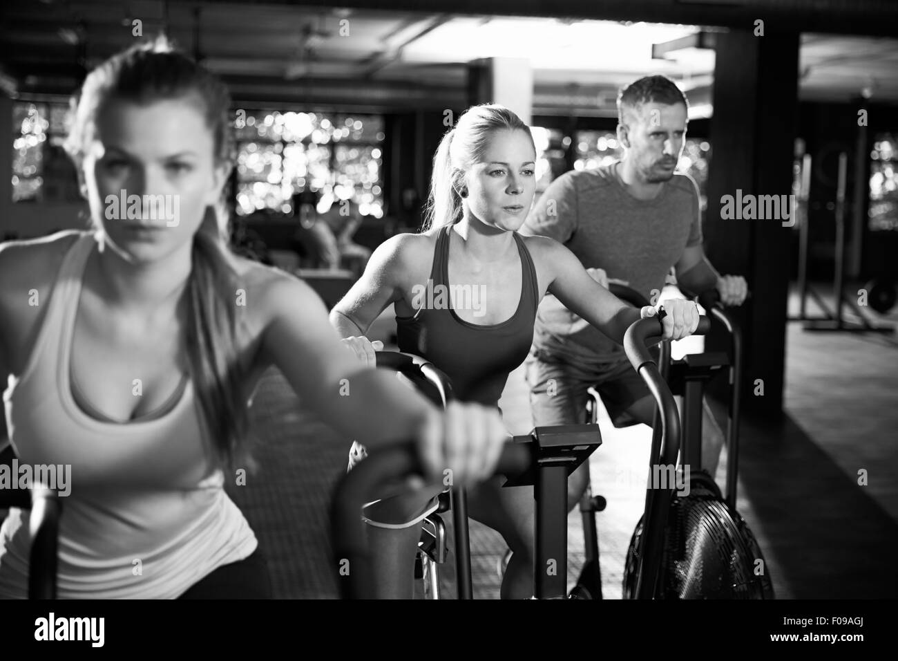 Black And White Shot Of Gym Class Using Cross Trainers Stock Photo