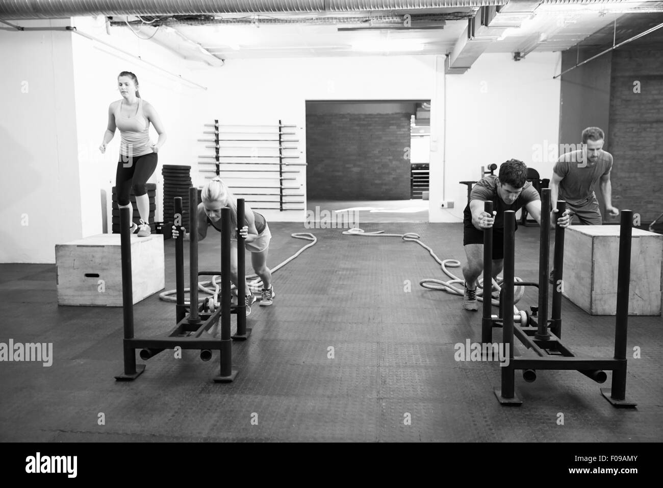 Black And White Shot Of People In Gym Circuit Training Stock Photo