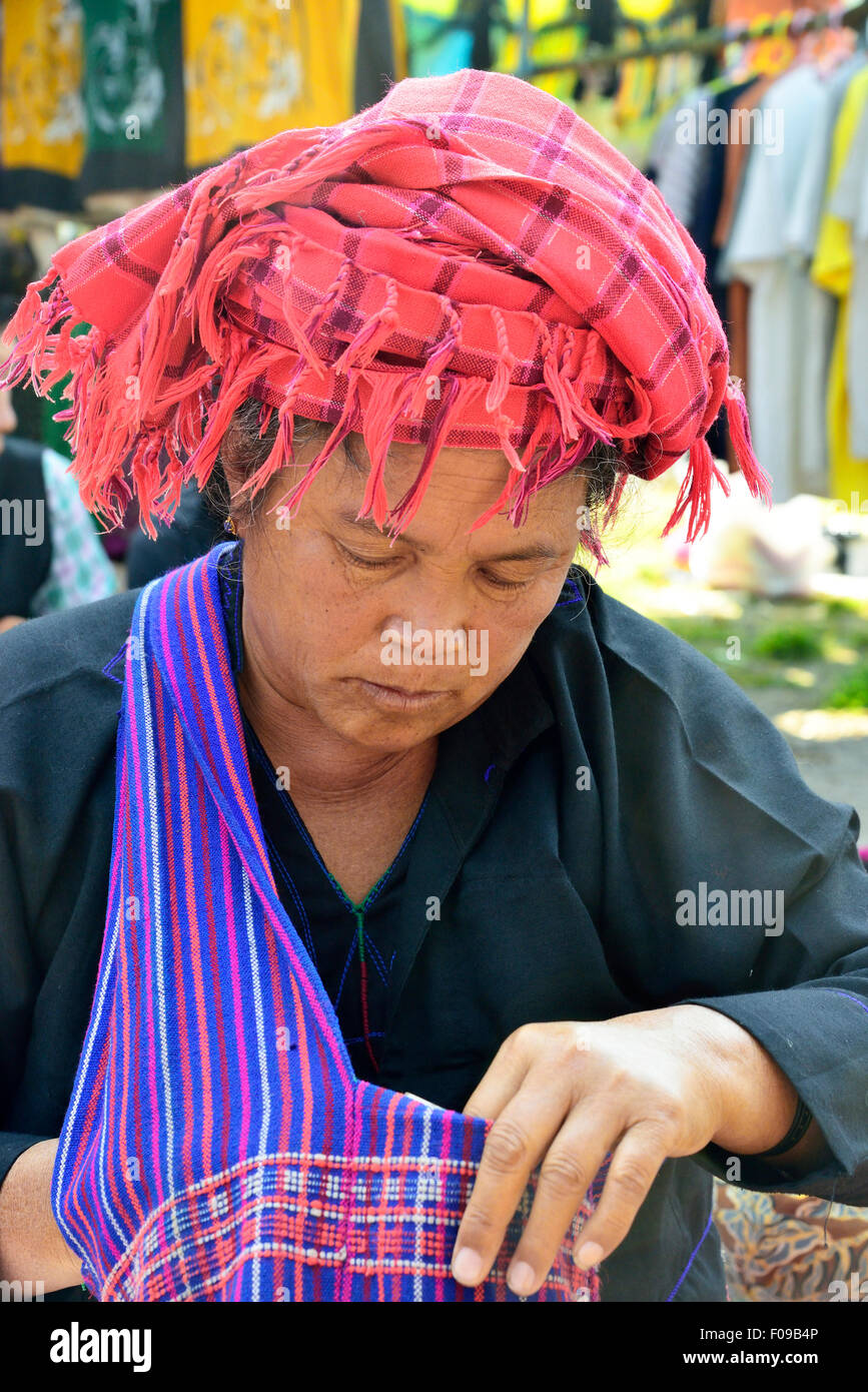 Pa-O woman market trader wearing the traditional plaid turban and Shan state bag Loikaw market, Myanmar, (Burma), Asia Stock Photo