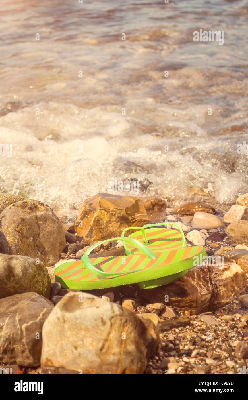 Flip flop on the beach. Shallow depth of field. Stock Photo