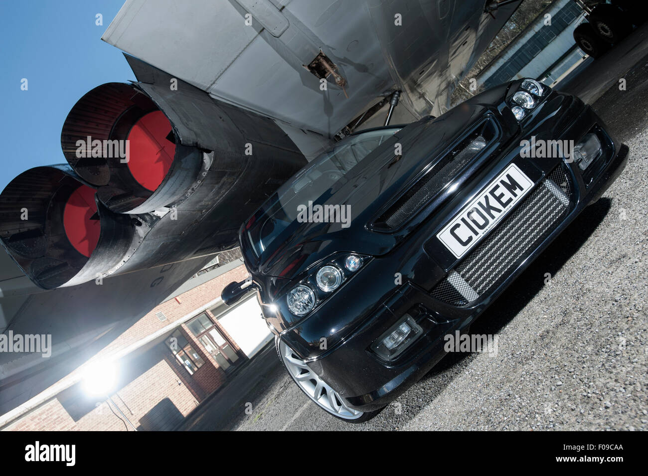 Modified Mk3 Vauxhall Astra car parked under a Concorde airliner Stock Photo
