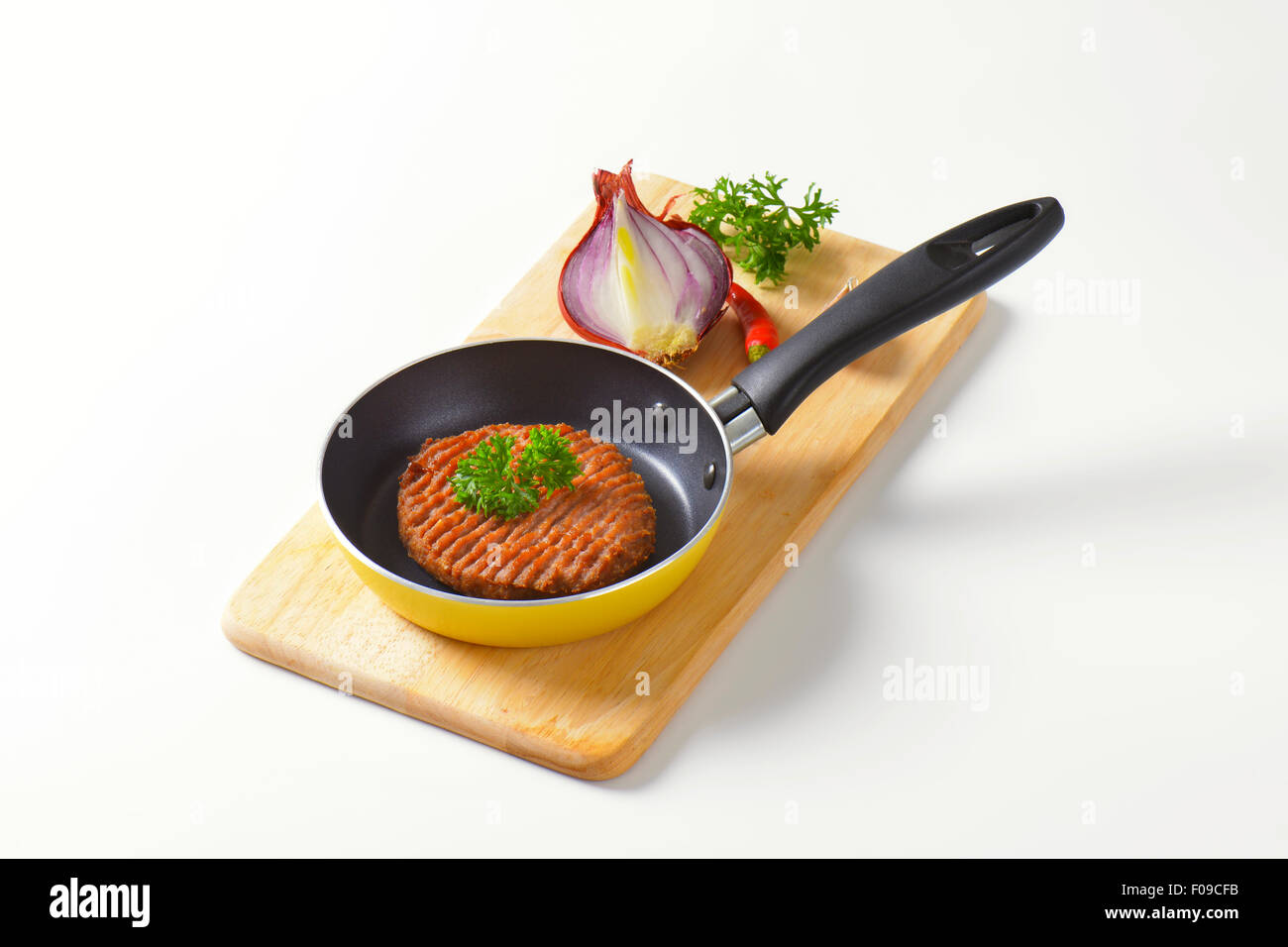 Panfried beef burger patty in pan Stock Photo Alamy