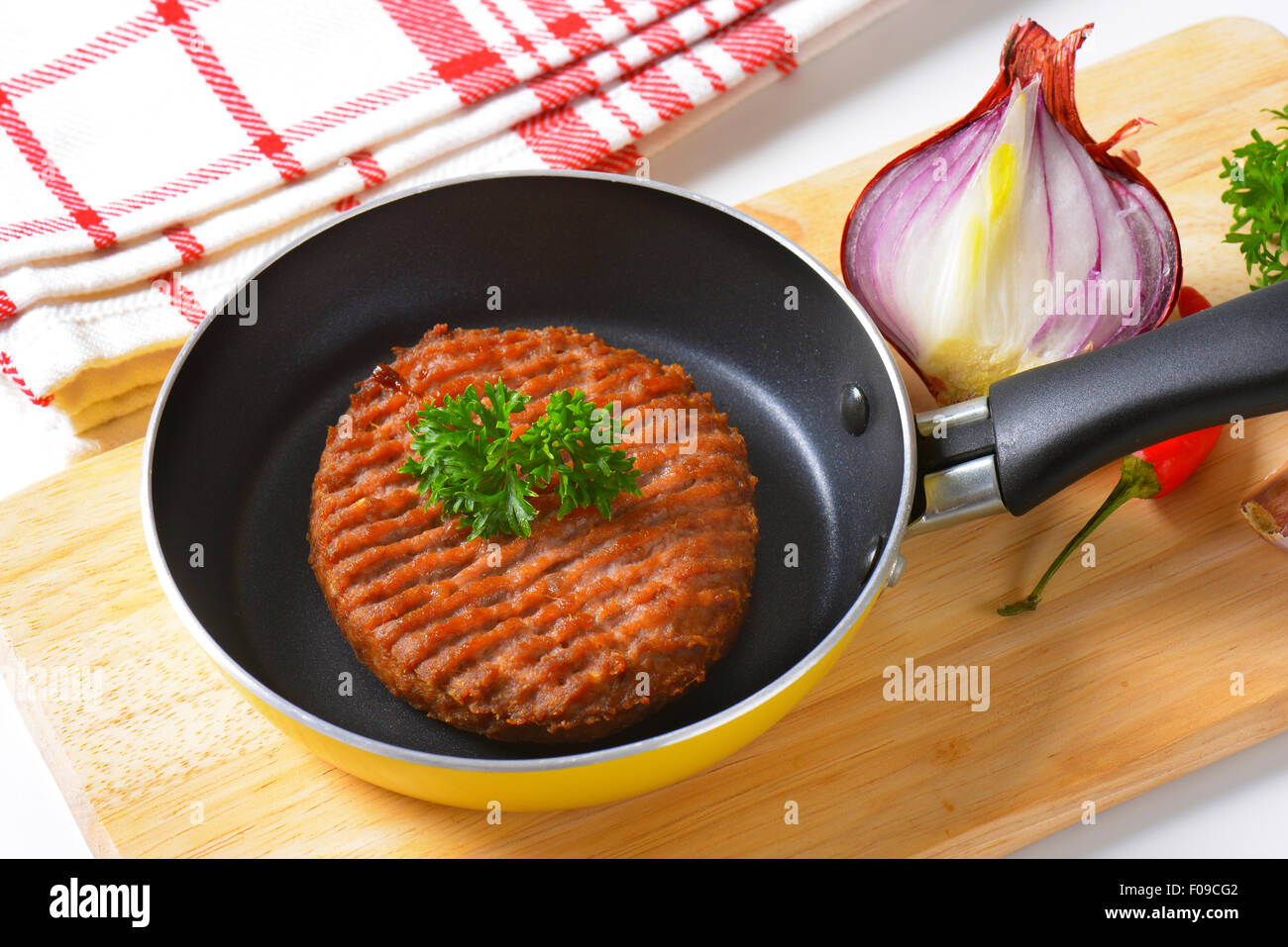 Panfried beef burger patty in pan Stock Photo Alamy