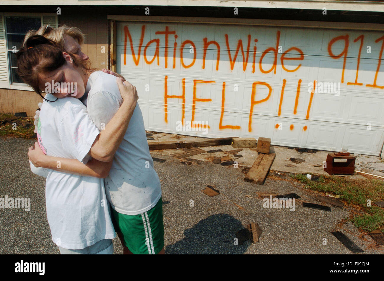 Sep 05, 2005; Pass Christian, MS, USA; New York Papers OUT! Linda Ladner hugs her daughter Michele Ladner, 20, who spray painted a message on her garage door as they return to collect salvageable personal effects in the aftermath of Hurricane Katrina in Pass Christian. Mandatory Credit: Photo by Bryan Smith/ZUMA Press. (©) Copyright 2005 by Bryan Smith Stock Photo