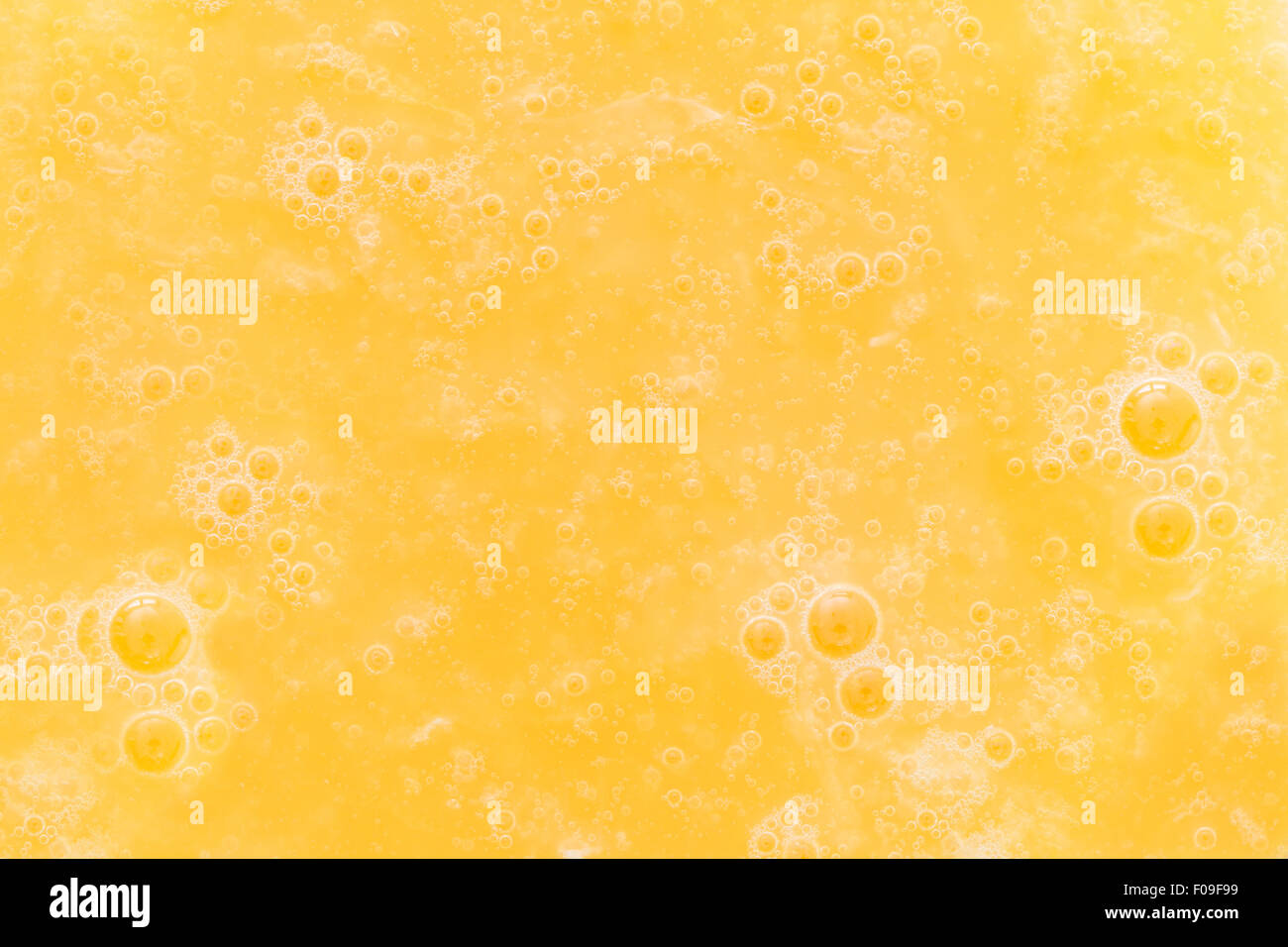 Closeup of bubbles in an yellow orange juice drink Stock Photo Alamy