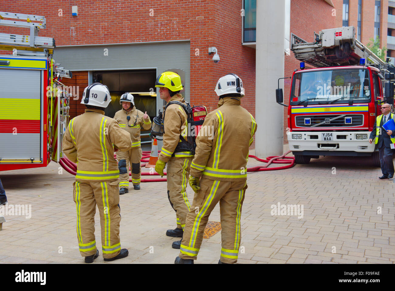 Firemen, from West Yorkshire fire service, in protective clothing attending fire in Leeds Stock Photo