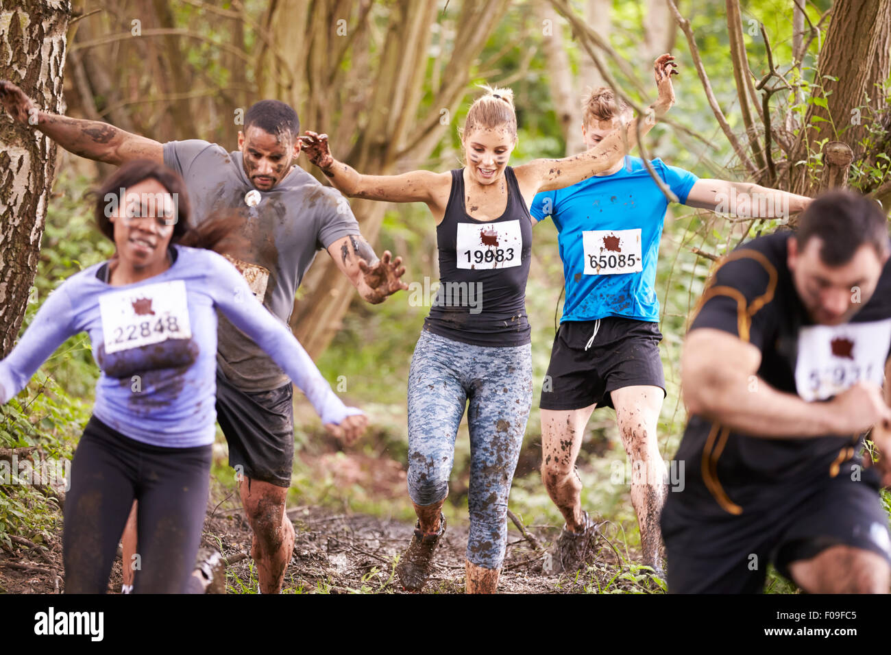 Competitors running in a forest at an endurance event Stock Photo