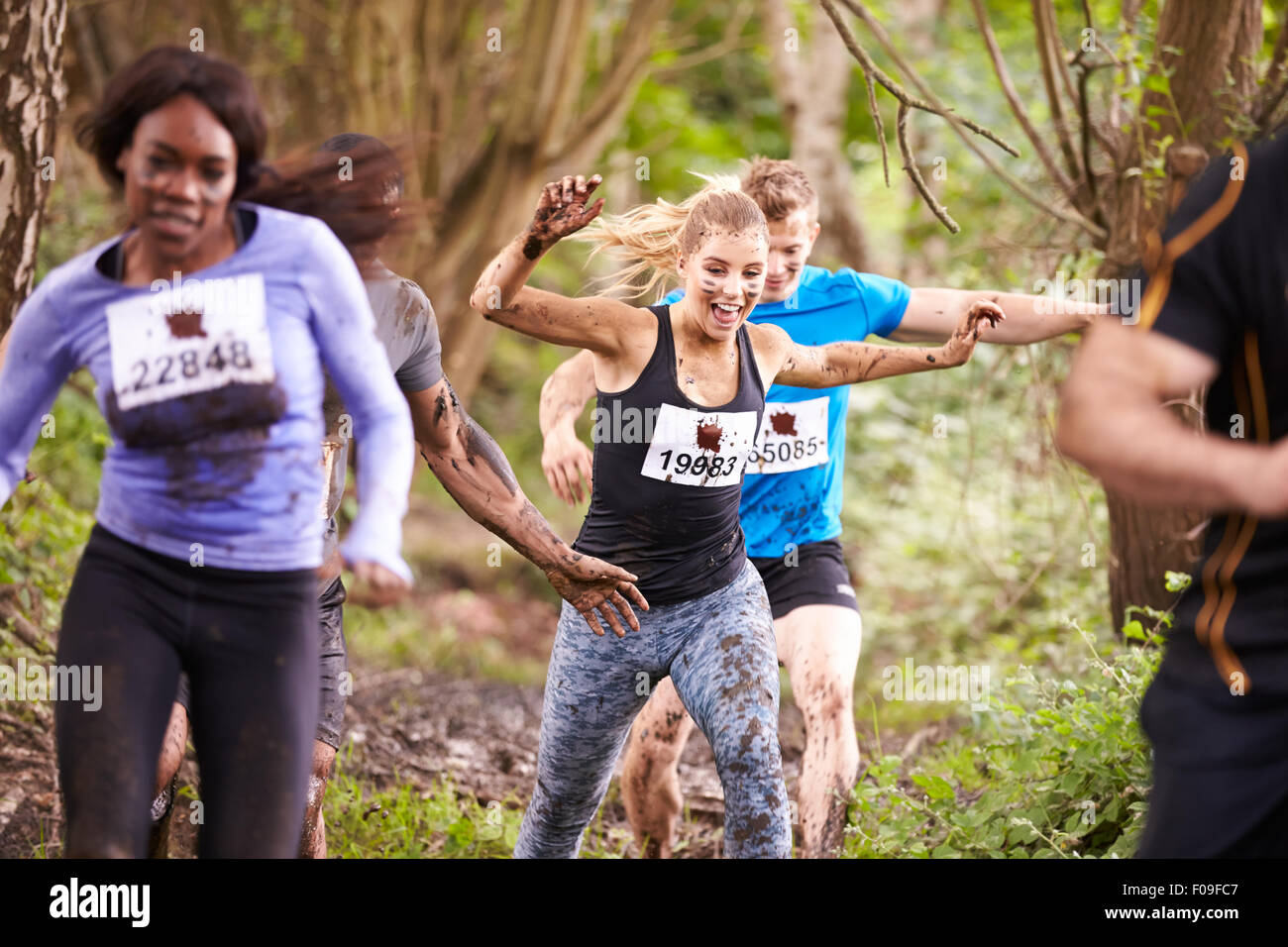 Competitors enjoying a run in a forest at an endurance event Stock Photo