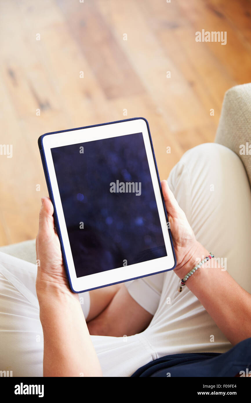 Close Up Of Woman Using Digital Tablet At Home Stock Photo