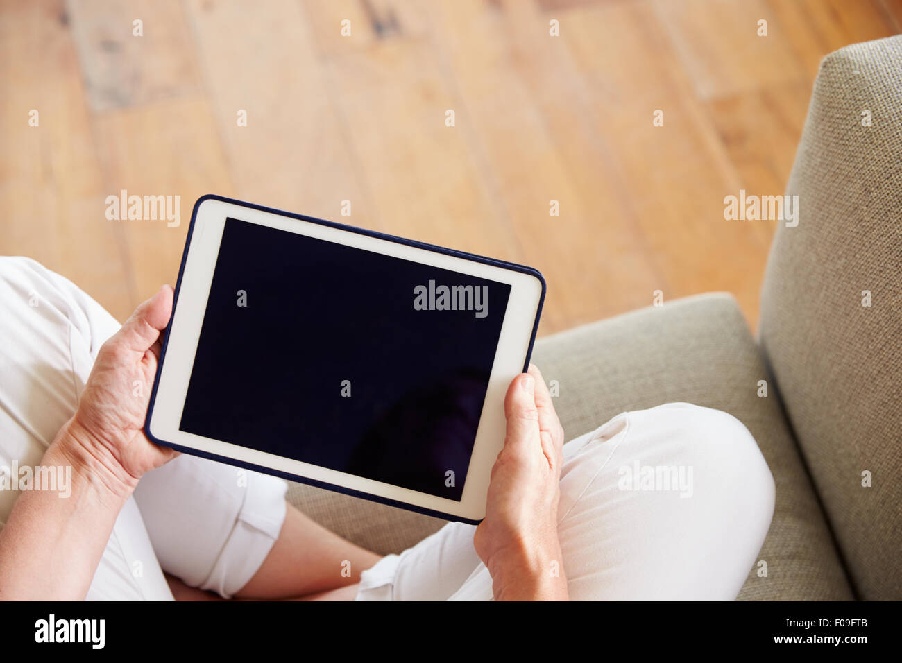 Close Up Of Woman Using Digital Tablet At Home Stock Photo