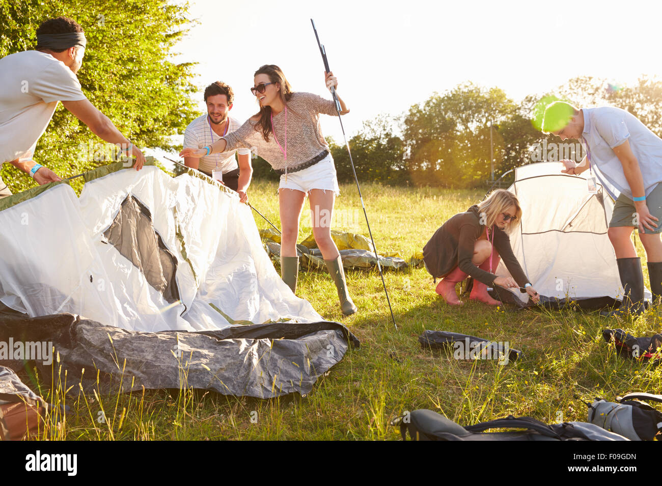 Group Of Young Friends Pitching Tents On Camping Holiday Stock Photo