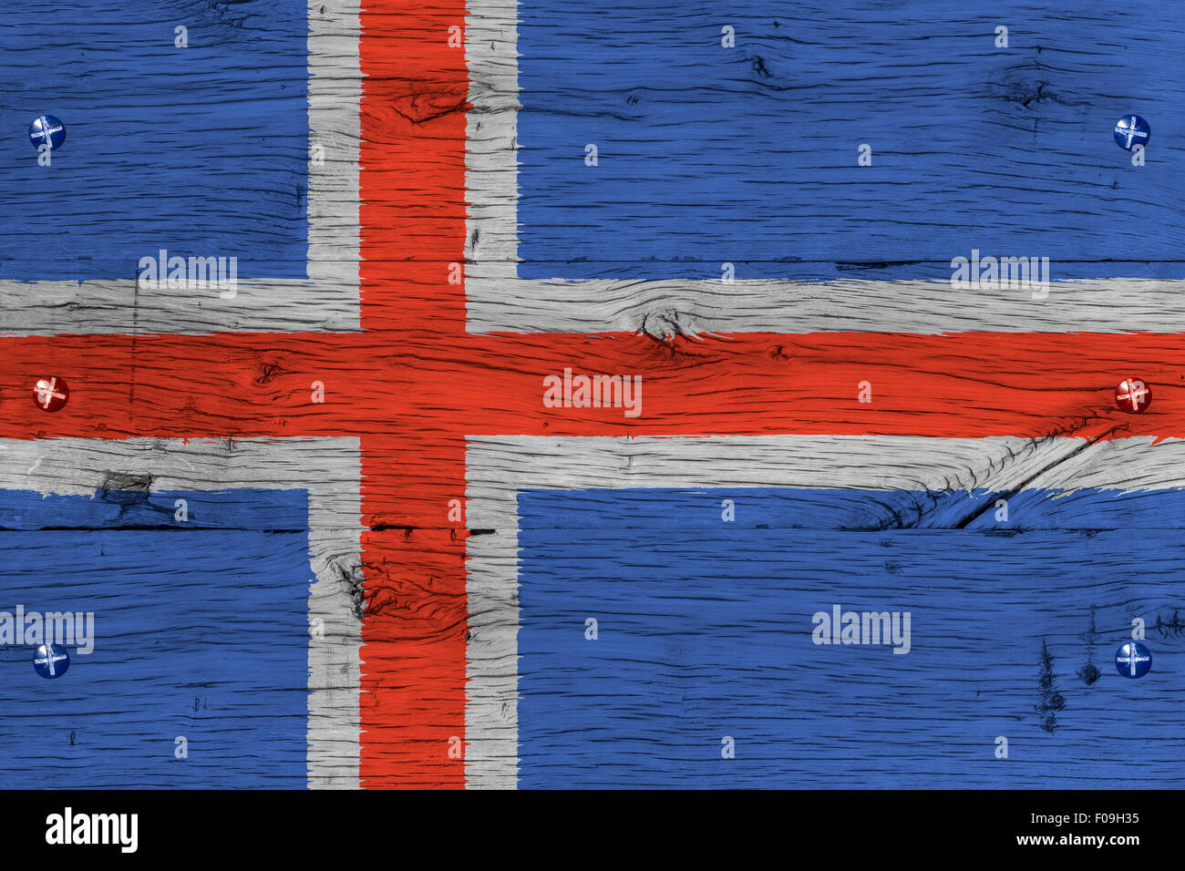 Iceland national flag. Painting is colorful on wood of old train carriage. Fastened by screws or bolts. Stock Photo