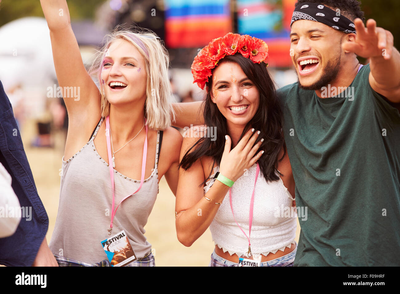 Three friends in the audience at a music festival Stock Photo