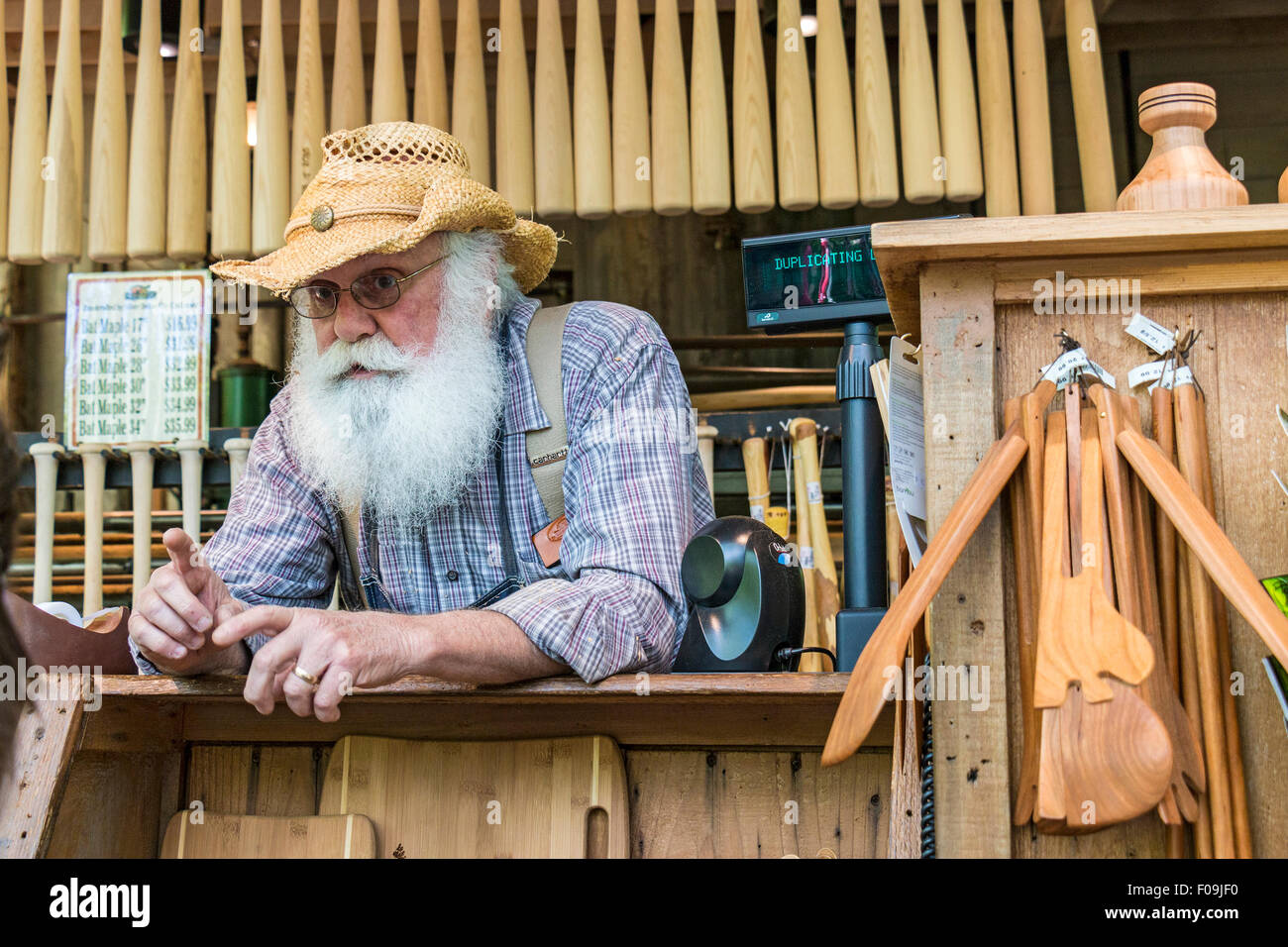One of several wood carvers at Silver Dollar City, an 1880s theme amusement park near Branson, MO. Stock Photo